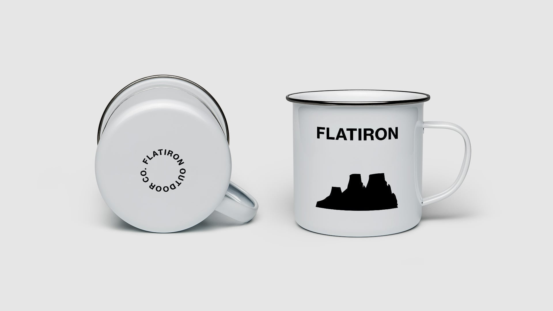 White enamel camping mugs showing front and bottom views with Flatiron wordmark and mesa rock formation silhouette logo