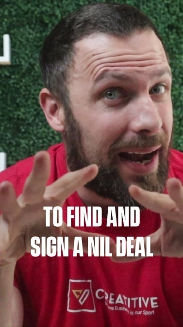 Zachary Colman speaking in YouTube video about finding and signing NIL deals, wearing red Creatitive branded shirt