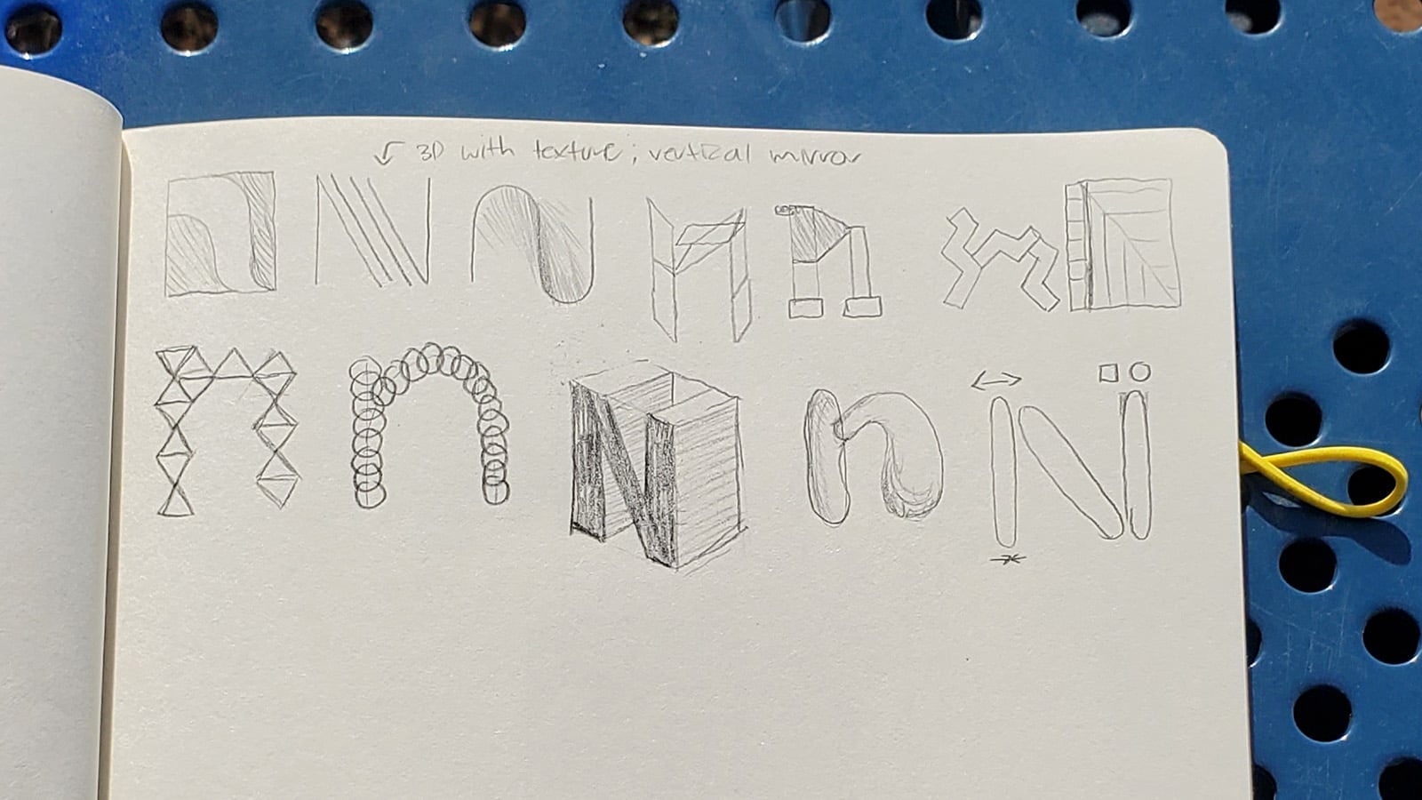 Sketchbook page with letter N explorations including 3D textures, geometric triangles, and organic curves