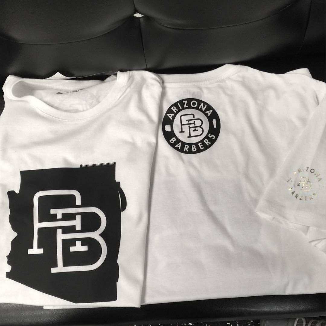 Folded white t-shirts displaying Arizona state AB monogram and circular badge logo designs