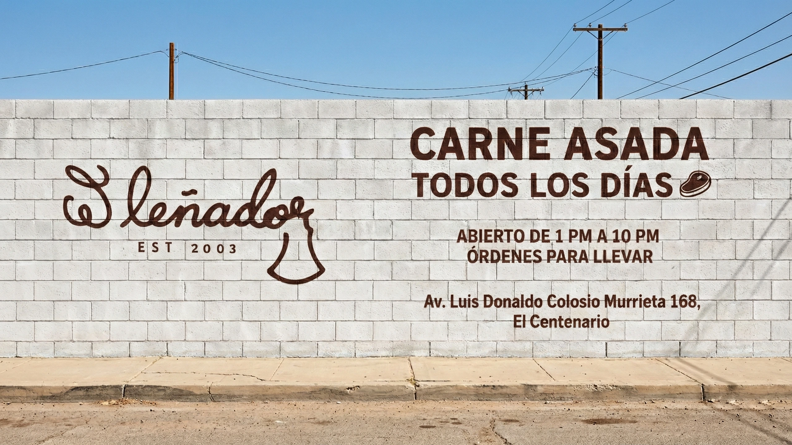 Hand-painted El Lenador mural on a gray block wall with cursive logo, cowbell icon, promotional text, hours, and address