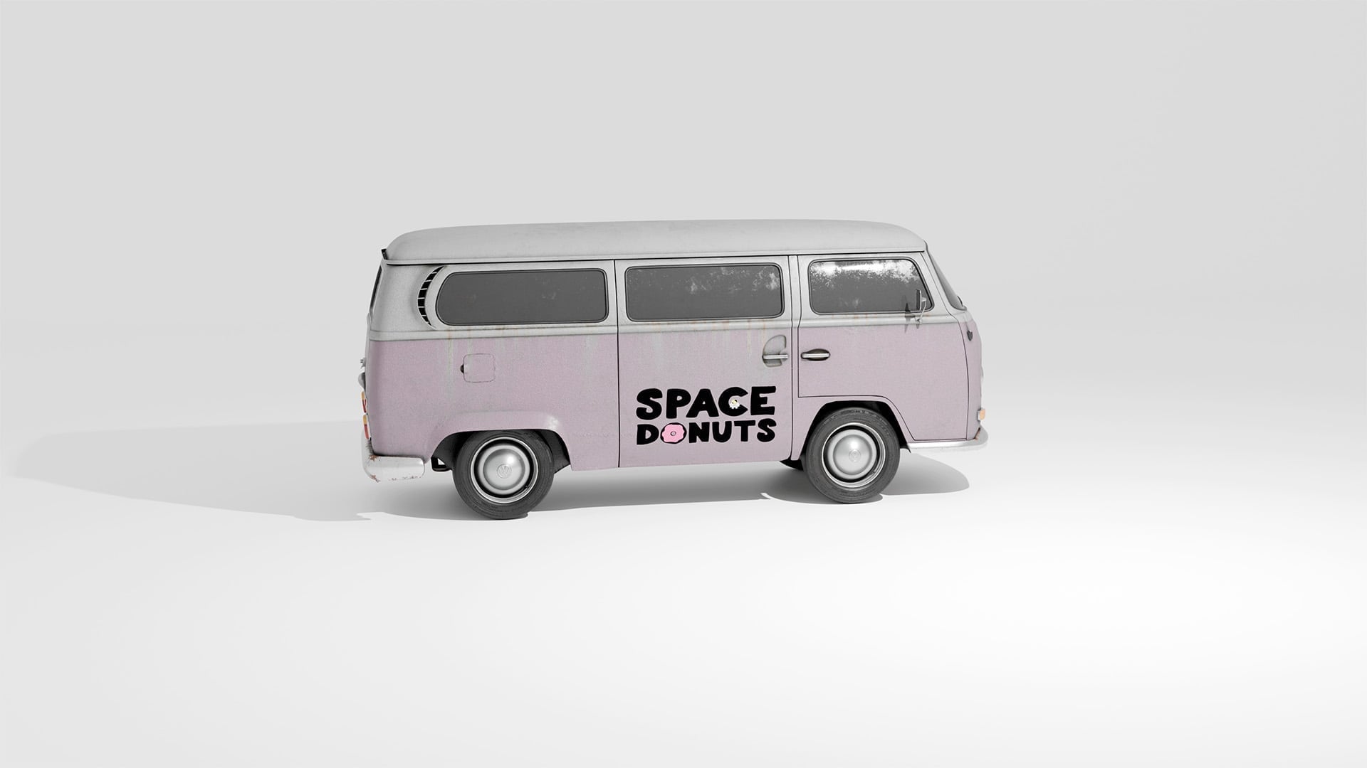 Side view of a vintage Volkswagen Type 2 van in dusty pink color with the Space Donuts logo featuring the pink donut O displayed on the side door panel, photographed on a neutral gray background